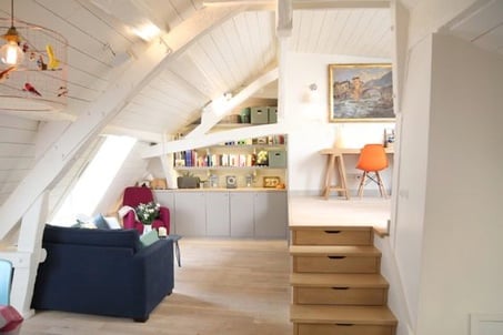 Attic living room with white walls to add brightness