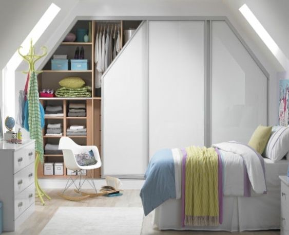 Classic fitted wardrobes for an attic bedroom